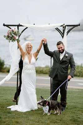 Couple and dog hooray beachfront wedding venue