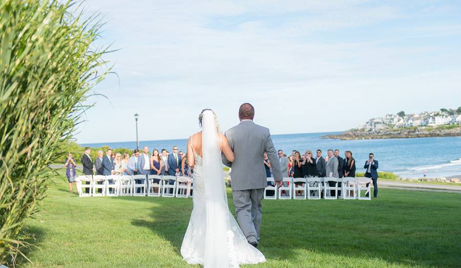Father walks bride down the aisle beachfront wedding